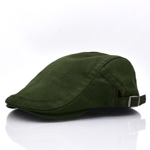 May include: A dark green, flat-topped, cotton cap with a buckle closure on the side.