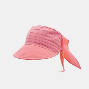 May include: A pink sun hat with a wide brim and a long scarf attached to the back.