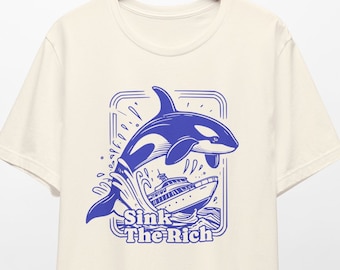 May include: A white t-shirt with a blue graphic of an orca jumping out of the water and sinking a yacht. The text "Sink The Rich" is printed below the orca.