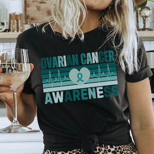 Concientización sobre el cáncer de ovario, Día Mundial del Cáncer de ovario, camisa con cinta verde azulado sobre el cáncer, camisa sobre el cáncer de ovario, regalos sobre el cáncer de ovario, cáncer de cuello uterino, o