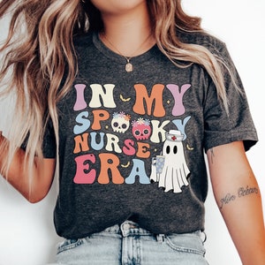 ハロウィンナースゴーストシャツ、不気味なRN Tシャツ、面白いICUナースTシャツ、救急看護師ハロウィンパーティーシャツ、秋のナースアパレル、ハロウィンナース