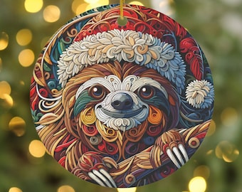 May include: Round Christmas ornament featuring a smiling sloth wearing a Santa hat. The ornament has a detailed, colorful design with shades of red, brown, blue, and green. A gold string is attached for hanging.