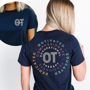 May include: A navy blue t-shirt with a white circle on the front that says "OT" with the name "Olivia" written underneath. The back of the shirt has a circle with the words "Motivated, Compassionate, Occupational Therapy, Passionate, Educated, Dedicated" written around the outside of the circle.