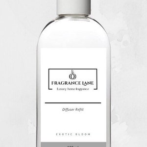 May include: A clear glass bottle with a white cap and a label that says "Fragrance Lane" and "Luxury home fragrance". The label also says "Diffuser Refill" and "Exotic Bloom" with a 200 ml volume.