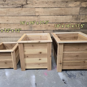 May include: Three wooden planter boxes in different sizes. The smallest is 12 inches by 12 inches by 12 inches. The middle size is 16 inches by 16 inches by 17.5 inches. The largest is 18 inches by 18 inches by 17.5 inches.