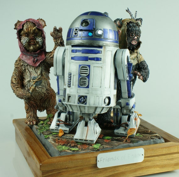 Friends of Endor, R2 poses in the Ewok village with the ewoks who commandeered the AT-ST ,Wunka and Widdle