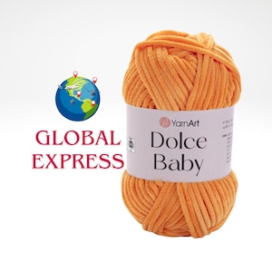 May include: A ball of orange Dolce Baby yarn by YarnArt. The label on the yarn ball includes the brand name and product name. The image also includes the text "GLOBAL EXPRESS" and a graphic of a globe.
