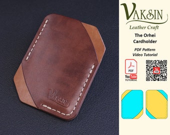 May include: A brown leather cardholder with a tan leather accent. The cardholder is stitched with white thread and has the word "VAKSIN" embossed on the front. The image includes a PDF pattern and YouTube tutorial for making the cardholder.