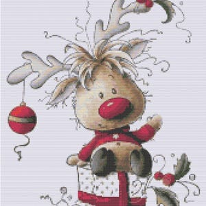 May include: A cartoon illustration of a reindeer wearing a red sweater and sitting on a wrapped gift. The reindeer has large antlers, a red nose, and is holding a red ornament. Holly and berries decorate the top and sides of the gift.