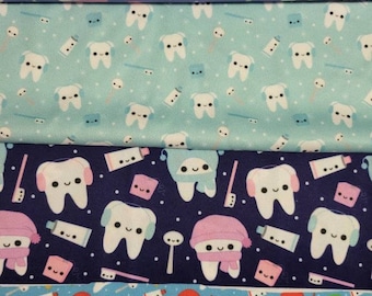 May include: A fabric pattern featuring rows of smiling cartoon teeth with accessories like hats and scarves, toothbrushes, toothpaste, and small pink squares. The background colors include purple, teal, navy, and light blue.