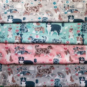 May include: A repeating pattern of Australian Shepherd dogs in various poses on a fabric background. The dogs are depicted in shades of brown, black, and white. The fabric is available in four colors: gray, light blue, pink, and white.