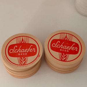 May include: A stack of brown paper coasters with the red text "Schaefer Beer" and the company name "The F. & M. Schaefer Brewing Co. New York and Albany, N.Y. and Baltimore, Md."