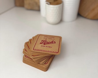 May include: A stack of brown cardboard coasters with the text "Welcome, you are in Stroh's Country" and the Stroh's logo in red.