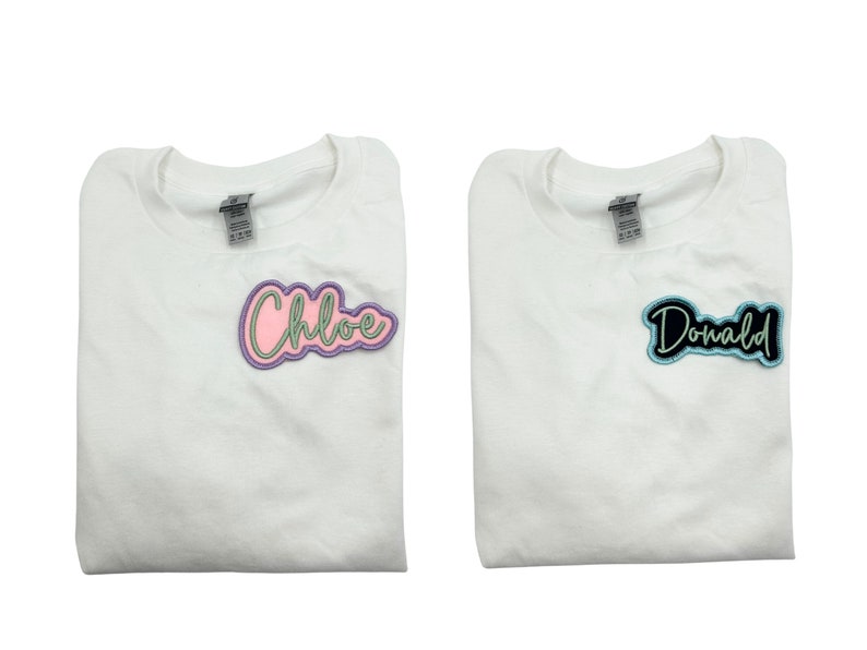 May include: Two white t-shirts with personalized names. The left shirt has a pink and green "Chloe" patch. The right shirt has a black and blue "Donald" patch.
