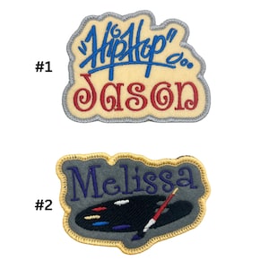 May include: Two embroidered iron-on patches. The first patch is beige with a blue and red design that says "Hip Hop" and "Jason". The second patch is grey with a purple design that says "Melissa" and features a paintbrush and palette.