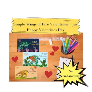 May include: A wooden desk displays three "Wings of Fire" Valentine's Day cards featuring dragon illustrations. The cards are accompanied by red heart cutouts, colored pencils, and a notepad. Text on the cards reads "Happy Valentines Day!"