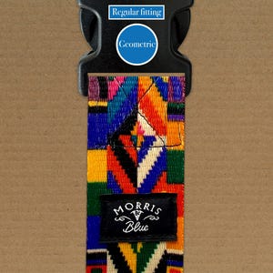 May include: A patterned strap with a black buckle. The strap has a geometric design in blue, orange, yellow, and red. The text "MORRIS Blue" is on a black label. The text "Regular fitting" and "Geometric" are also visible.
