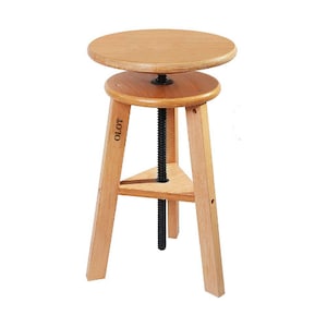 May include: A light-coloured wooden artist's stool with a round seat and a triangular base. The stool has a black threaded rod for height adjustment. The word "OLOT" is printed on one of the legs.
