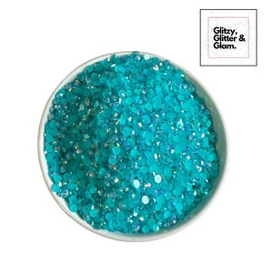 May include: A bowl filled with turquoise blue iridescent rhinestones.