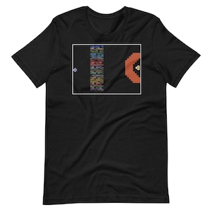 May include: Black t-shirt with a white rectangle containing a pixelated image of a video game scene. The scene shows a spaceship flying through a colorful, pixelated tunnel.