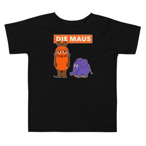 Puede incluir: Camiseta negra para niños con un ratón y un elefante de dibujos animados. El texto "DIE MAUS" está impreso en naranja sobre los personajes.