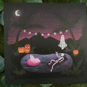 May include: A spooky Halloween scene with a skeleton relaxing in a pool float, a ghost floating in the air, and pumpkins on the ground. The scene is set at night with palm trees and string lights.