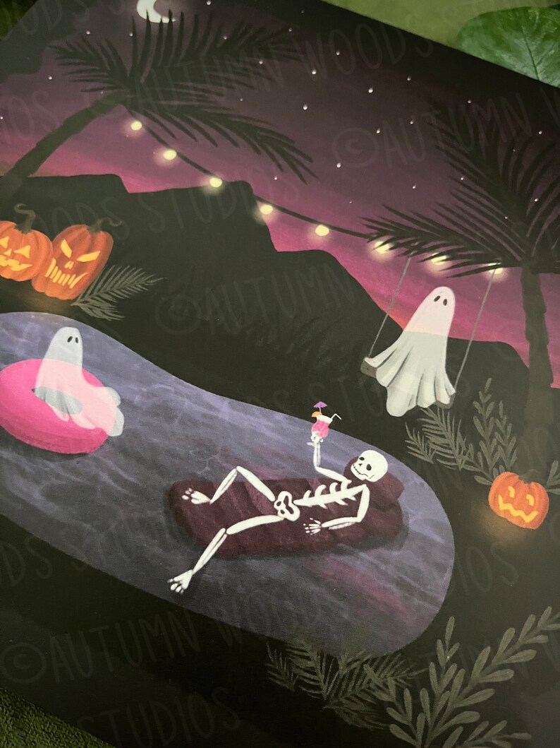 May include: A spooky Halloween illustration of a skeleton relaxing in a pool with a cocktail, a ghost floating in a pink inflatable ring, and another ghost swinging on a swing. The scene is set at night with palm trees, string lights, and jack-o-lanterns.
