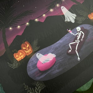 May include: A spooky Halloween pool party scene with a skeleton in a pool float, a ghost on a swing, and pumpkins. The scene is set at night with a purple sky and string lights.