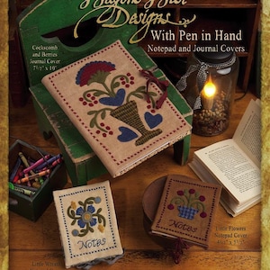 May include: A book cover design pattern with the title "Wagons West Designs With Pen in Hand Notepad and Journal Covers". The design features a floral motif with a vase and berries. The book cover is 7.5 inches by 10 inches.