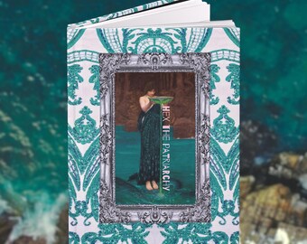 May include: Open journal with a teal and white paisley design. The cover features a framed image of a person in a long green dress holding a bowl. The text "HEX THE PATRIARCHY" is printed vertically on the right side of the image.