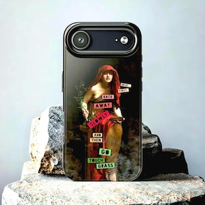 May include: Black phone case featuring a classical painting of a woman in a red robe holding a plant. Text on the case reads "Back Away Slowly And Then Go Touch Grass" in various colors. The case has a black camera lens.