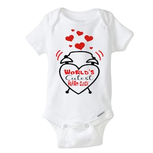 May include: White baby onesie with a black and red graphic of a heart-shaped drum set with the text "World's Cutest Alarm Clock".