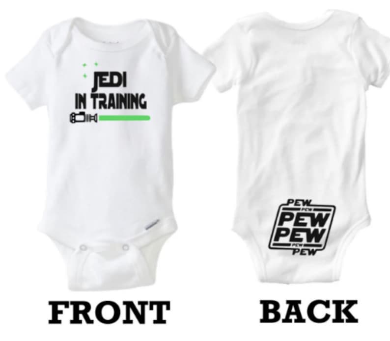 May include: White baby onesie with the text "Jedi in Training" and a green lightsaber graphic on the front. The back of the onesie has the text "Pew Pew Pew" in a black box.