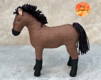 May include: Brown felt horse with black mane and tail, black felt hooves, and a white stripe on its face. PDF pattern.
