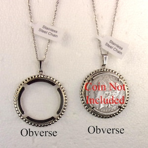 May include: Two stainless steel chain necklaces with coin bezels. One bezel is empty, the other holds a coin. The text "Coin Not Included" is visible. Each necklace has a tag that reads "Stainless Steel Chain".