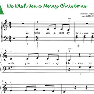 May include: Sheet music for the song We Wish You a Merry Christmas, arranged by Debbie Frandsen. The page features a green Christmas tree icon, musical staves with notes, lyrics, and finger numbering for piano performance in 3/4 time signature.