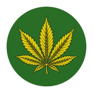 May include: A circular sticker featuring a vibrant yellow cannabis leaf illustration centered on a solid dark green background. The leaf has detailed black line work defining its serrated edges and veins, creating a sharp contrast against the green.
