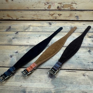May include: Three leather dog collars in black, brown, and tan. The collars are made of suede and have a buckle closure.