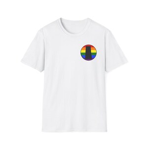 May include: White t-shirt with a crew neck and short sleeves. A circular emblem on the chest features a rainbow-coloured arc with a black vertical shape in the centre. The shirt is made of a soft, lightweight fabric.