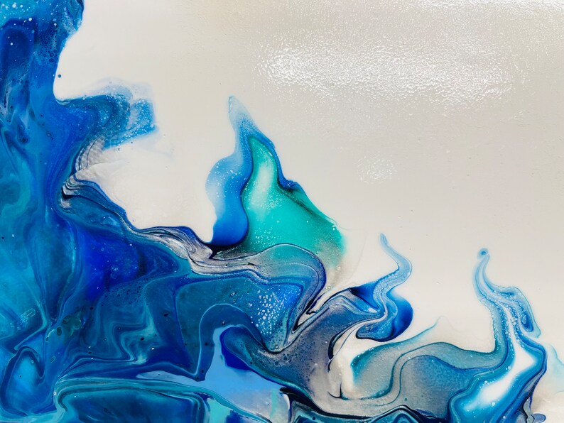 May include: Abstract painting with swirling blue, teal, and white paint. The paint creates a wave-like pattern.