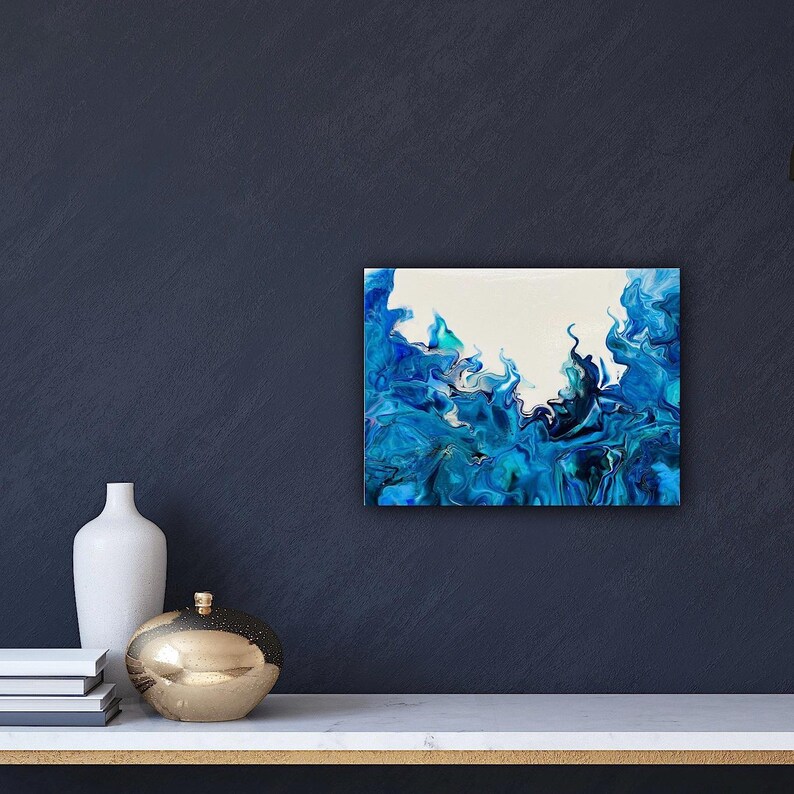 May include: Abstract painting with blue and white colors. The painting features swirling, fluid shapes that resemble waves or smoke. The background is white, and the blue paint is layered on top, creating a sense of depth and movement.