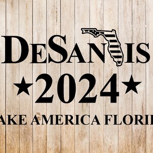 May include: A political campaign poster with a woodgrain background. The poster features the text "DeSantis 2024" with a star on either side of the year. The poster also includes the text "Make America Florida" and an outline of the state of Florida with an American flag pattern.