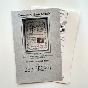 May include: A cream-colored paper pattern for a cross-stitch sampler featuring a house and a tree with the alphabet. The pattern is titled "Davenport House Sampler" and is part of the "Historic Savannah Series" from "In Stitches".