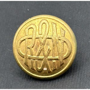 May include: A gold-colored metal button with the letters "R.H.A." embossed in a circular design.