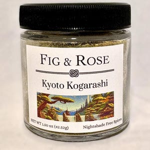 May include: A clear glass jar with a black lid, filled with a green spice blend. The label reads "FIG & ROSE Kyoto Kogarashi" with a scenic illustration. Net weight is 1.50 oz (42.52g).