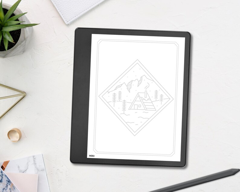 May include: A black e-reader displays a line drawing of a cabin in a mountain landscape. The drawing is framed within a diamond shape. The e-reader is on a white surface with a succulent plant, a gold ring, and a pen.