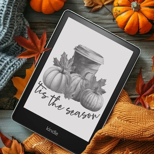 May include: A black and white Kindle e-reader with the text "'Tis the season" and a graphic of a coffee cup and pumpkins.