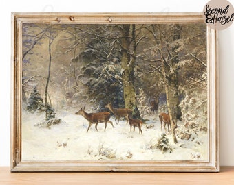 Puede incluir: Una pintura vintage enmarcada de una escena de bosque nevado con un grupo de ciervos caminando por la nieve. La pintura está en un marco de madera claro.