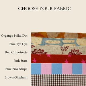 May include: A fabric selection guide titled CHOOSE YOUR FABRIC featuring six horizontal swatches: orange polka dot, blue tie-dye, red chinoiserie floral, pink stars on red, blue and pink vertical stripes, and a brown and white gingham check pattern.