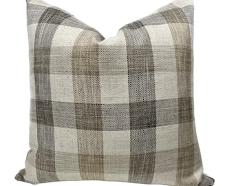 May include: A brown and gray plaid throw pillow with a white background.